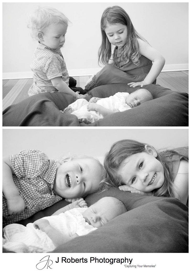 Older brother and sister looking after newborn baby boy - newborn baby portrait photography sydney